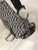 Christian Dior Black Monogram Saddle Bag front side showing strap connection to C & D silver rings & curved flap in grey
