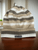 Dolce and Gabbana Wool Beanie Front view of ribbed cuff & beige, brown, white horizontal stripes & D&G logo