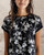 Edition Black Short Sleeve Floral Top front view worn on model with black base and white & green florals