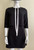 Fashion Union Neck Tie Black Mini Dress closer front view with front bodice flap, white necktie handing loose