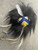 Fendi Monster Bag Charm - top down full view of blue & yellow face, black & white hair & silver Fendi branded hardware clasp
