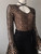 Gert Johan Coetzee Black & Gold Bodysuit angled front view showing neckline black tie & black & gold geometric pattern