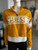 Guess Half-Zip Crop Logo Sweater front view in mustard yellow with bold GUESS logo panel in white & half-zip collar