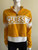 Guess Yellow Logo Crop Sweater front view in mustard yellow with bold GUESS logo panel in white & half-zip collar