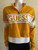 Guess Yellow Logo Crop Sweater front view in mustard yellow with bold yellow GUESS logo on white panel & half-zip collar