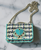 Kate Spade Nicola Tweed Twistlock Bag front in Fuji green heart twist-lock & trim, multicolour tweed flap & silver chain