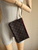 Louis Vuitton Neverfull Monogram Pochette on mannequin wrist showing LV monogram canvas & beige leather strap