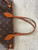 Louis Vuitton Monogram Canvas Neverfull PM front showing wear & discoloration  on handles & leather accents & trim