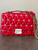Michael Kors Red Leather Crossbody Bag front view with gold chain strap hanging over the right side of the bag