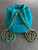 Moschino Turquoise Quilted Mini Backpack back view with small slip pocket & double chain & matching leather straps