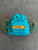Moschino Turquoise Quilted Mini Backpack front flat lay with gold eyelets & MOSCHINO logo & straps rolled to the sides