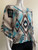 News Geometric Pattern Poncho – front angled with turquoise, cream, black &  brown print, styled on mannequin