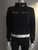 Nike Cropped Black Fleece Sweater front view with half zip, gold “Just Do It” slogan & swoosh on collar