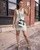 Olive De Olive White Bodycon Mini Dress on model with Moschino Black & White Bucket Bag & Jeffrey Campbell White Sandals