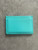Prada Turquoise Leather Card Holder back view with smooth finish and stitched edges showing 1 card slot