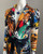 Shein x De Johnea Bianca Multicolour Jumpsuit closeup chest, black belted waist, V-neck & graphic graffiti print