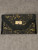 Black Laser-Cut Turn Lock Envelope Clutch front flat lay with floral laser-cut detailing & metallic gold showing through