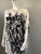 Black & White Graffiti Mini Dress angled front view showing bold black graphic print & draped long sleeve