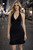 Black Halter Neck Mini Dress front view worn on model with plunging neckline, fitted silhouette & ruffle hem