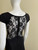 Black Sheer Detail Maxi Dress back view which sheer floral lace across on upper back, zip & black skirt