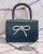 Black Mini Crossbody Bag with Bow Detail front with silver chain, smooth body, top handle & rhinestone silver bow on flap