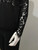 Vero Moda Sheer Black Blouse close arm view showing cuff detail with delicate floral overlay.