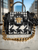 Versace La Medusa Tweed Handbag front view in black-white houndstooth, gold Medusa emblem & chunky short gold chain
