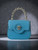 Versace La Medusa Turquoise Mini Bag front view with silver Medusa head plaque & twisted metallic silver tone handle