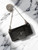 Black Mini Crossbody Bag front flay lay with structured  body, wide front strap, silver metal accent & ball chain strap