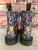 Dr. Martens 1460 Pascal Wanderlust Boots back view with multicolor floral print leather & black heel tabs with yellow script