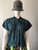 Canifa Teal Short Sleeve Zip Blouse – front view showing ring pull zip, black collar & flap chest pockets