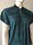 Canifa Teal Short Sleeve Zip Blouse angled front with full zip with flap panel, folded cuffs & short black collar