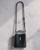 Woolworths Black Crossbody Twist Lock Bucket Bag - front view hanging with smooth black finish, gold twist lock & long strap