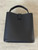 Woolworths Black Crossbody Twist Lock Bucket Bag back view showing 4 gold bag feet, smooth finish & flap for twist lock