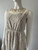 Cream Lace Cut Out Sleeveless Mini Dress angled front view with brown lining from bust level with cut out detail at the neck