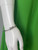 Mango Green Halter Neck Maxi Dress close up of vibrant green soft fabric & Just Cavalli silver cuff bracelet on mannequin arm