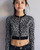 Michael Kors Black Leopard Print Cropped Knit Zip Jacket front view in white base with black & light grey animal print