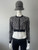 Michael Kors Black Leopard Print Cropped Knit Zip Jacket full front view with black ribbed neckline & hem & silver MK logo zip