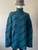 Balenciaga Oversized Teal Monogram Wool Jersey front view in petrol teal blue with black diagonal logos & long sleeves