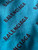 Balenciaga Oversized Teal Monogram Wool Jersey back view highlighting tiny snag, 7cm from underarm & 15cm across