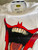 Replay Tribute Limited Edition White Joker T-Shirt flat lay of inner label, inner neck batman logo tape & big joker mouth graphic