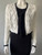 White Front Tie Cropped Chunky Knit Cardigan closer front showing black front tie & black trim on neckline, hem & cuffs