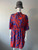Blue & Orange All-Over Print Mini Dress front view with slightly elevated collar, loose fit split sleeves & mini above knee length