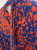 Blue & Orange All-Over Print Mini Dress close up of matching long neck tie at the back of the mannequin neck