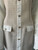 Shein White & Tweed Bodycon Mini Dress close up of tan & cream tweed panel & embossed gold-tone decorative buttons