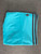 Adidas Blue Firebird Track Pants in turquoise blue shade folded view showing Adidas trefoil logo