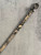 Woolworths Snake Print Skinny Belt front view in beige, tan, black, set against a warm yellow-toned background