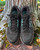Adidas Terrex Black Trail Running Shoes resting against a tree wuth black base & laces & turquoise 3 stripes on the sides