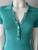 Guess Turquoise Ribbed Knit Bodycon Mini Dress close up GUESS branded silver half-press button placket 3 open & 3 closed