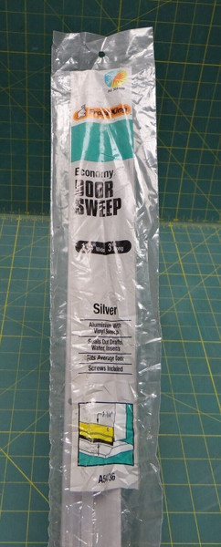 Opened Frost King A54/36H 36 in L x 1-1/4 in W, Aluminum/Vinyl Silver Door Sweep